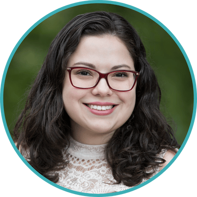 Headshot of Dr. Alexis López, a Latinx psychologist with medium length dark hair and fair complexion. She is wearing glasses and a white blouse.