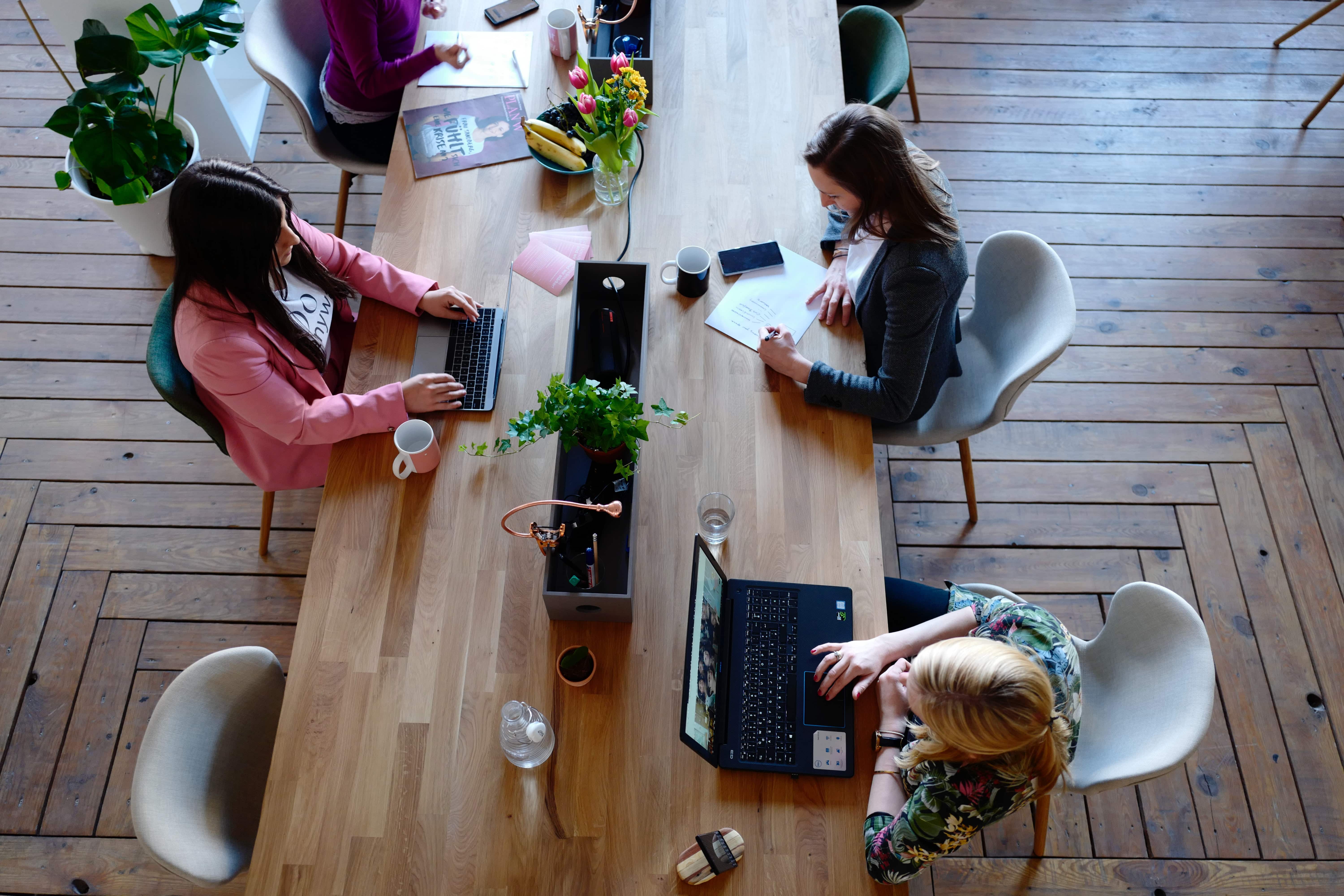 A photo showing, from above, a table of women working.