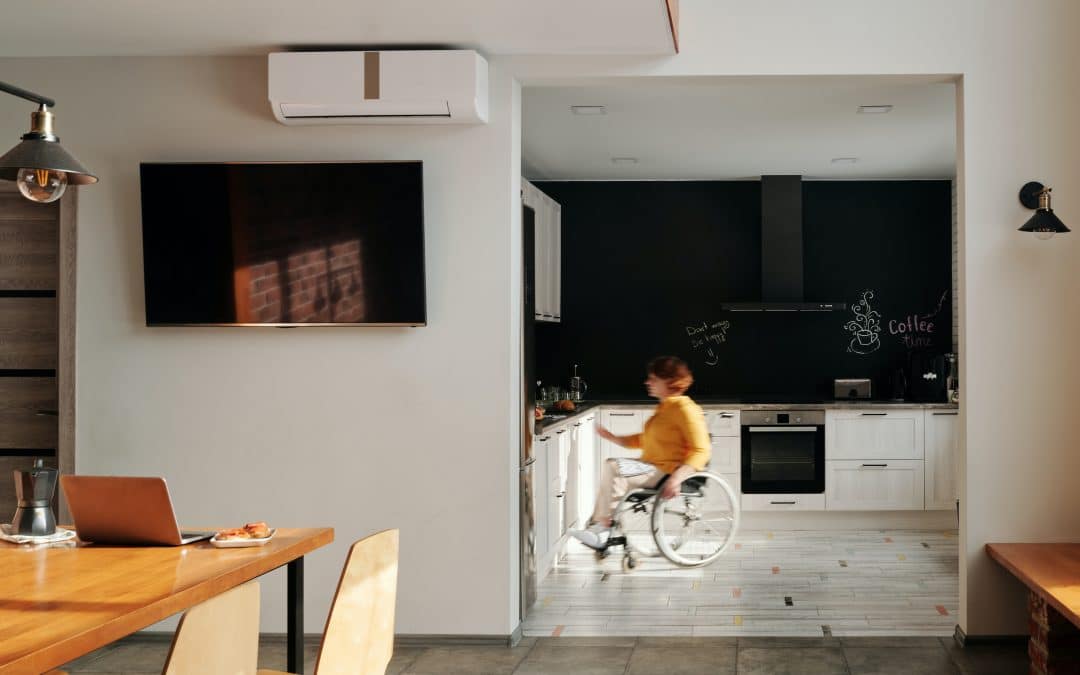 a stock photo of a white woman in her kitchen in a wheelchair