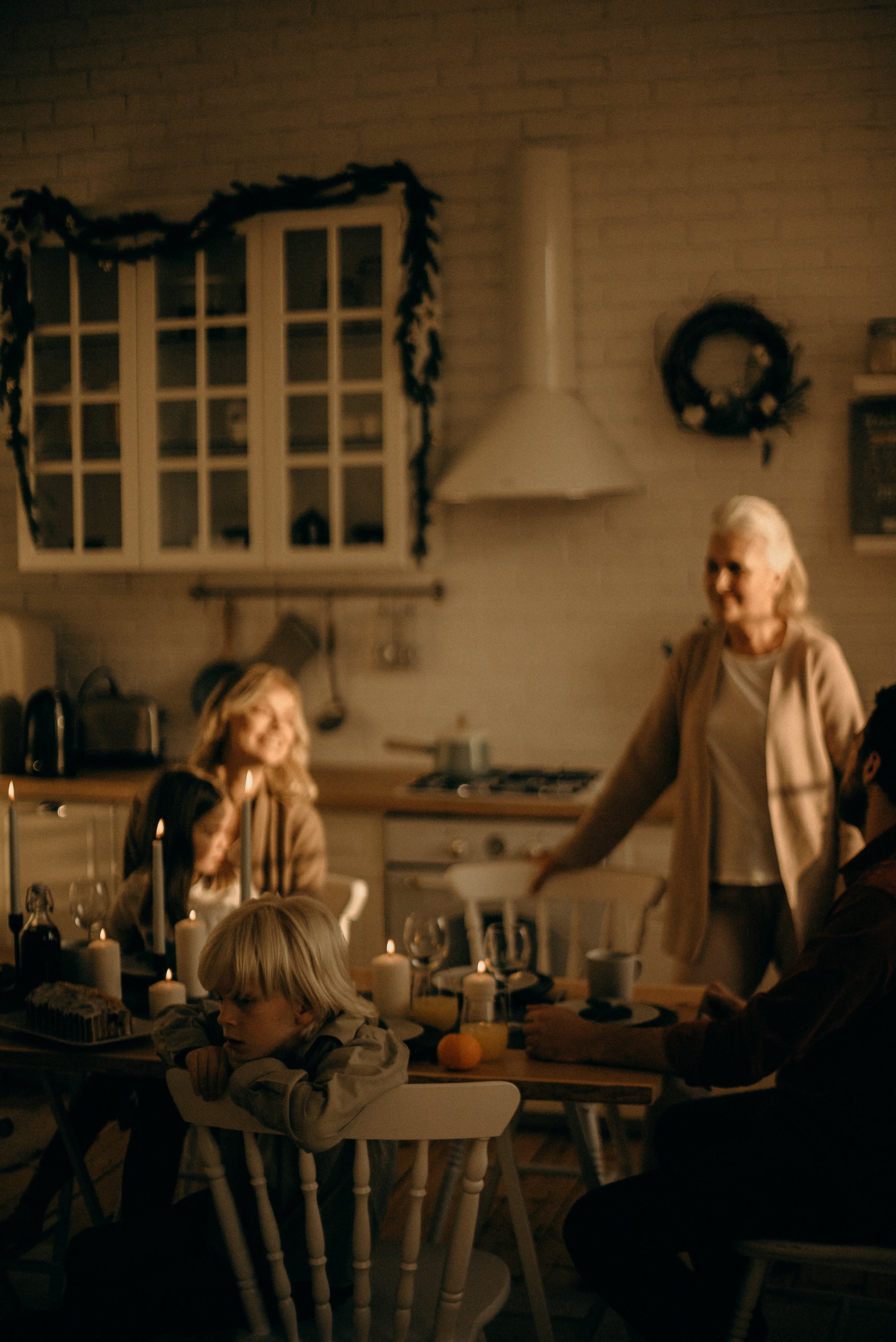 Three generations of white women sitting around a holiday table.