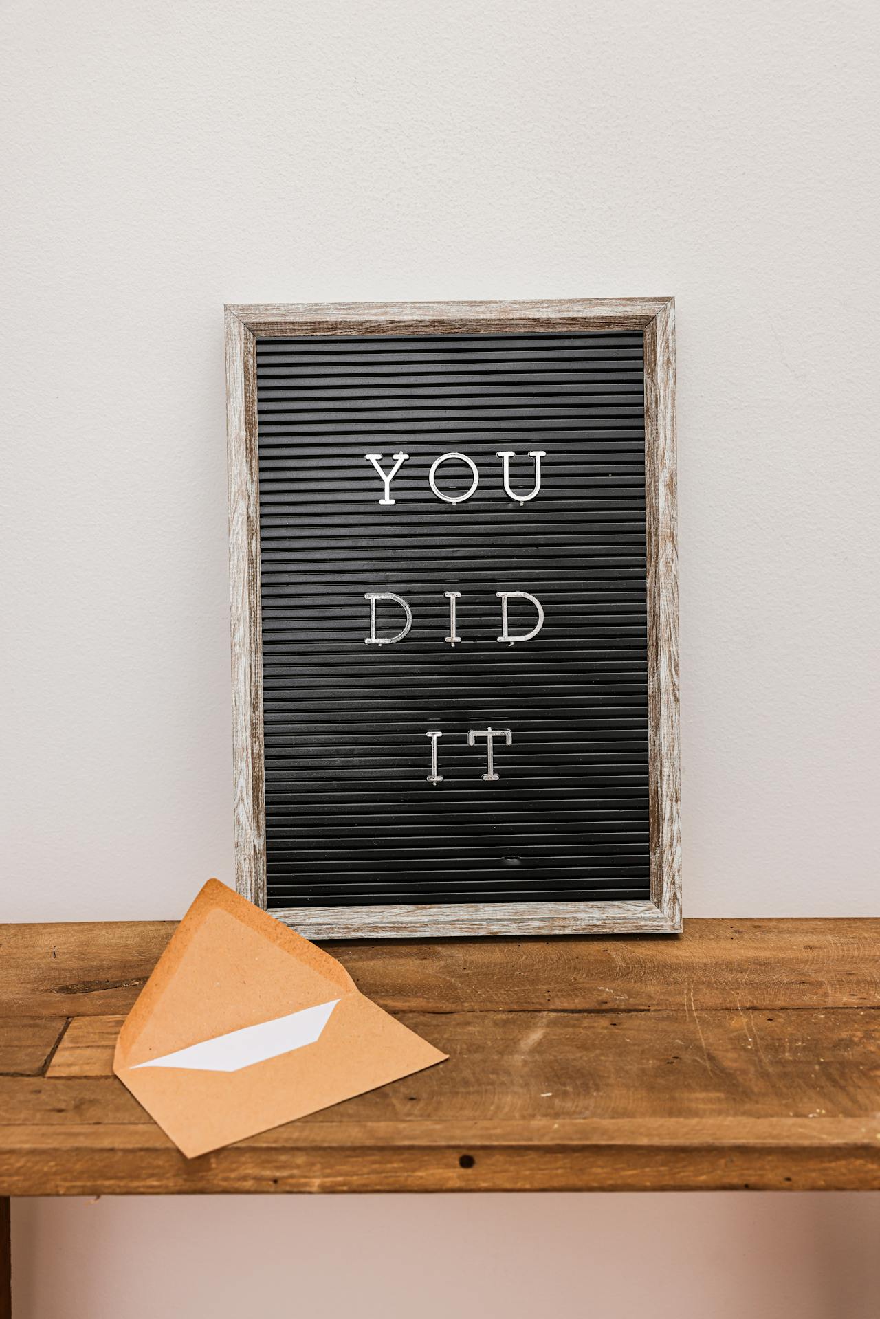 A black board reads "you did it!" In white letters. 