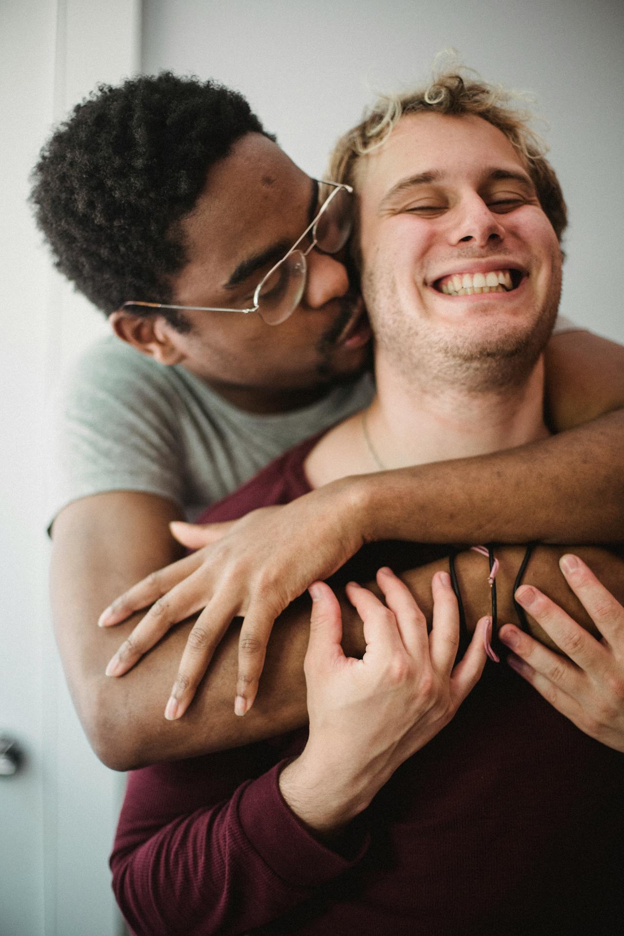 A gay couple holding each other